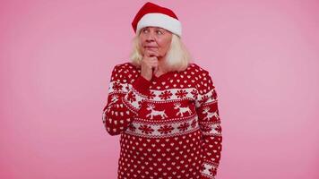 Grandmother in Christmas sweater make gesture raises finger came up with creative plan good idea video