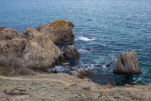 big stone rock over the sea water photo