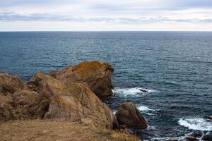 big stone rock over the sea water photo