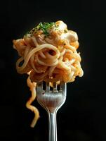 AI generated Fresh bite of hot spaghetti wrapped on fork against the dark black background photo