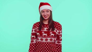 Young adult girl in Christmas sweater listening music, dancing disco fooling around having fun video