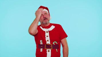 Upset man in Christmas red t-shirt making face palm gesture, feeling bored, disappointed, bad result video