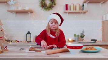 Senior family grandparents with granddaughter in Santa Claus hats preparing, cooking homemade cookie video