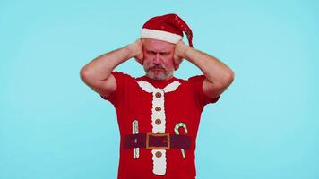 Man in Christmas t-shirt covering ears and gesturing no, avoiding advice ignoring unpleasant noise video