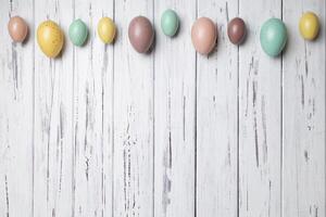 Multicoloured Easter eggs on white vintage aged wooden background. Copy space photo