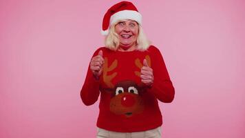 Grandmother woman in sweater Christmas Santa shouting, celebrating success, winning, goal achievemen video