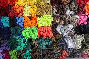 Detailed close up view on samples of cloth and fabrics in different colors found at a fabrics market photo