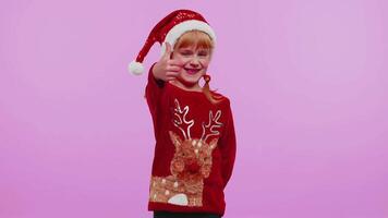 Funny girl in red New Year sweater raises thumbs up agrees something good, like, violet background video