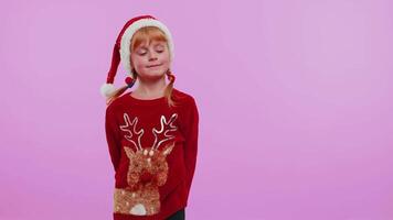 Girl in red New Year sweater deer showing thumbs up and pointing at on blank advertisement space video