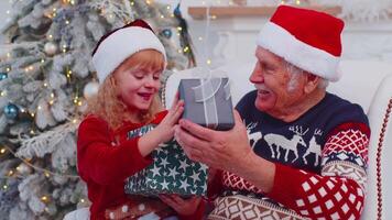 Enkelin Austausch Weihnachten Geschenk Geschenk Kisten mit erstaunt glücklich Alten Großvater beim Zuhause video