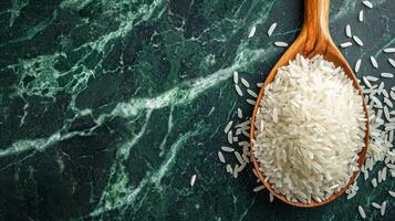 AI generated Spoon of uncooked rice on green marble table, top view. Banner with copy space. Concept of cooking ingredient, food, healthy nutrition, cereal grain, and agricultural product photo