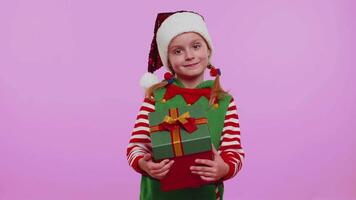 Cheerful girl Christmas Santa Claus Elf getting present gift box, expressing amazement happiness video