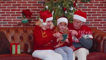 Senior family grandparents, granddaughter purchase online Christmas gifts on mobile phone, shopping video