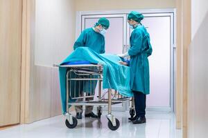 Medical team moving a patient to surgery in the operating room at the hospital photo