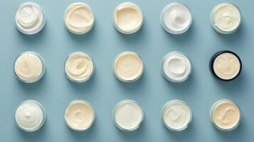 AI generated Variety of organic cosmetic creams for skin care in open jars on a blue background. Top view. Concept of skincare variety, cosmetics assortment, and beauty product display photo