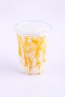 Iced Caramel Milk. Beverage for summer with brick wall background. photo