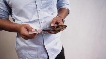 de cerca de hombre utilizando inteligente teléfono para en línea compras con crédito tarjeta. un hombre lugares un orden en un Tienda o paga un factura. video