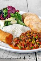 minced meat with vegetables, rice, fried banana and pastry photo