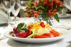 tropical salad with tomatoes, strawberries, carrots and cheese photo