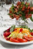 tropical salad with tomatoes, strawberries, carrots and cheese photo