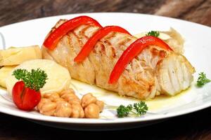 grilled cod with potatoes on plate photo