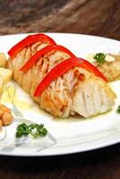 grilled cod with potatoes on plate photo