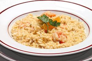 shrimp risotto with cheese on plate photo