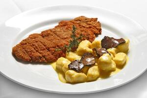 Breaded fillet with truffle gnocchi photo