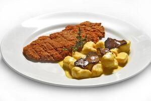 Breaded fillet with truffle gnocchi photo