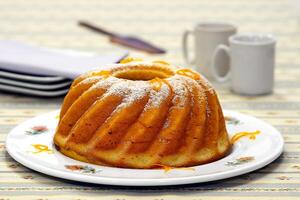 orange cake with coffee on the table photo