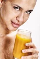 beautiful smiling girl with her orange juice photo