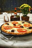 delicious Margherita pizza on the table photo
