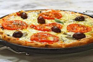 delicious Margherita pizza on the table photo