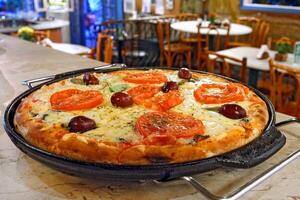 delicious Margherita pizza on the table photo