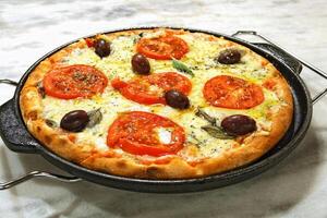 delicious Margherita pizza on the table photo