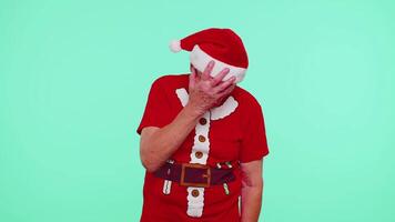 Upset senior Christmas old man making face palm gesture, feeling bored, disappointed, bad result video