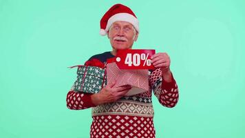 Grandfather in Christmas sweater showing gift box and 40 Percent discount inscriptions banner text video