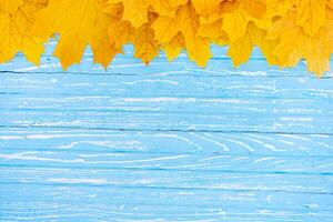 Autumn leaves frame on wooden background top view Fall Border yellow and Orange Leaves vintage wood table Copy space for text. photo