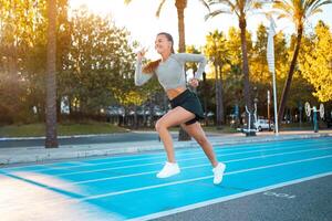 Sportswoman on starting line running track photo