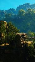 A scenic view of a mountain range with trees and rocks video