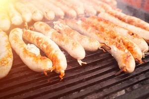 BBQ with fiery sausages on the grill photo