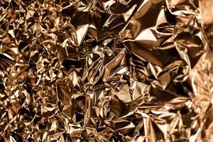 Full frame take of a sheeT of crumpled gold aluminum foil photo