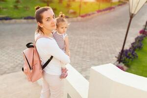 Mother hugging with her little daughter outdoor in nature on sunny day Positive human emotions, feelings, emotions. photo