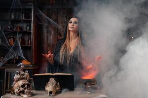 Halloween, witch use magic book and cauldron prepare poison or love potion photo