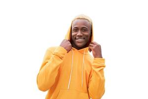 Young black man feeling happy, positive and successful, achievements or good luck isolated on white background. African ethnicity male person yellow hair yellow hoodie photo