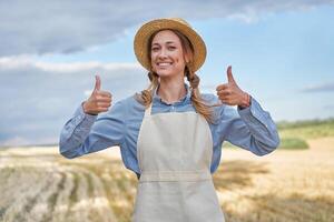 Woman farmer straw hat apron standing farmland smiling Female agronomist specialist farming agribusiness Happy positive caucasian worker agricultural field photo