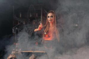 Halloween, witch use magic book and cauldron prepare poison or love potion photo