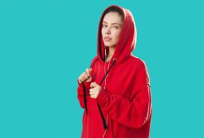 Beautiful caucasian sporty woman to trendy red hoodie photo
