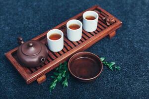 Traditional tea ceremony accessories Chinese clay teapot with green and puer tea photo