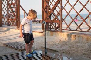 Caucasian boy standing beach. Childhood summertime. Family vacation photo